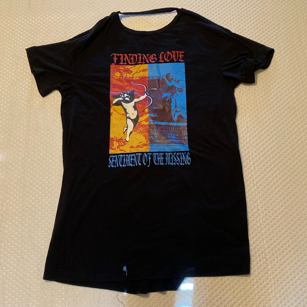 Over sized T-shirt dress. The back is twisted and has a strap at the top.
